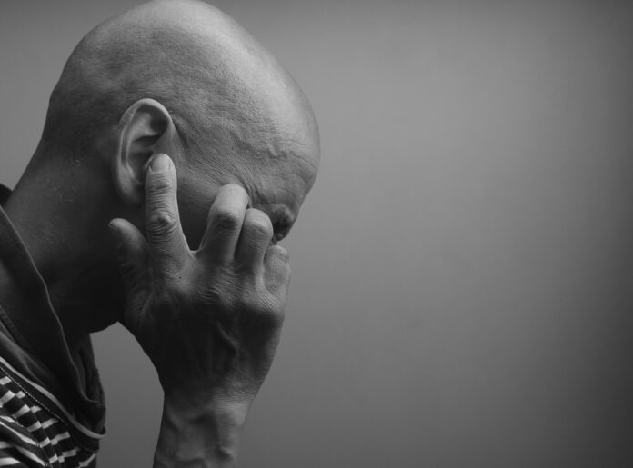 Man,Suffering,From,Deafness,And,Hearing,Loss,On,Grey,Background